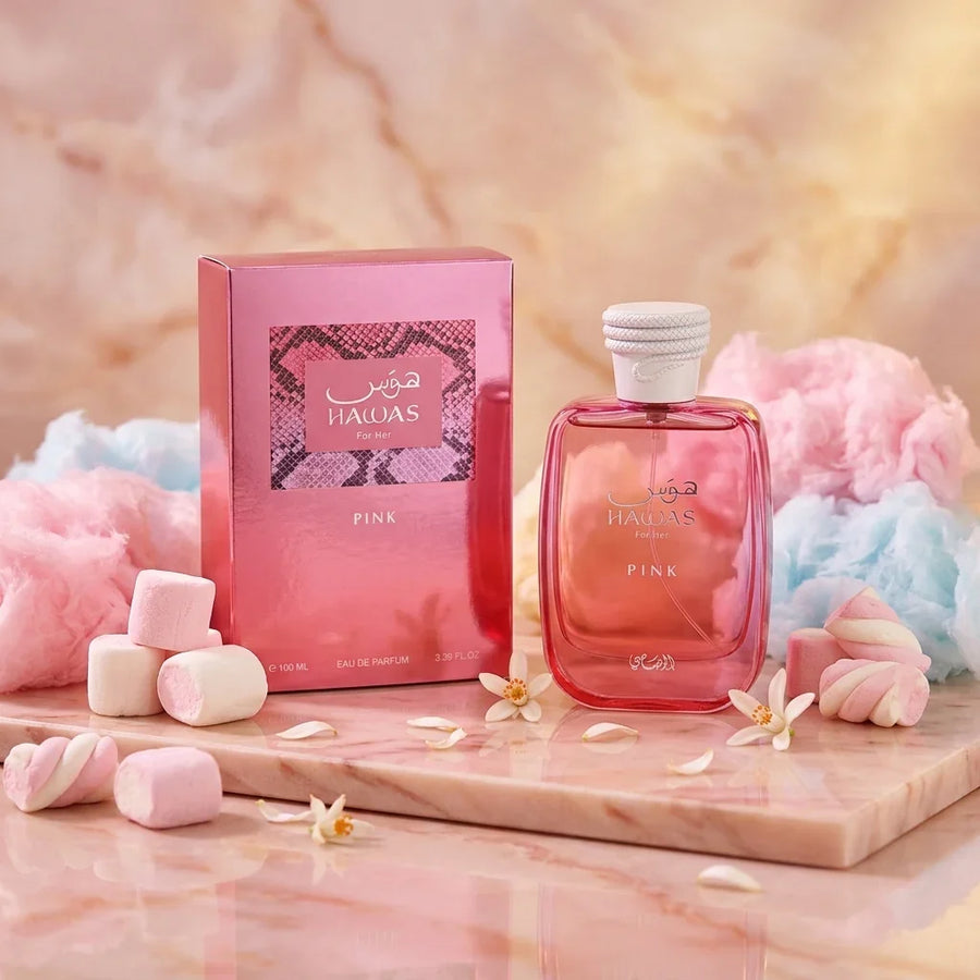 Pink Hawas For Her perfume bottle and box with marshmallows, cotton candy, and flower petals