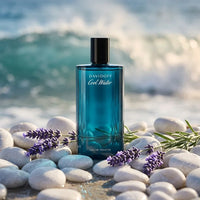 Davidoff Cool Water perfume bottle on white pebbles with lavender by the ocean