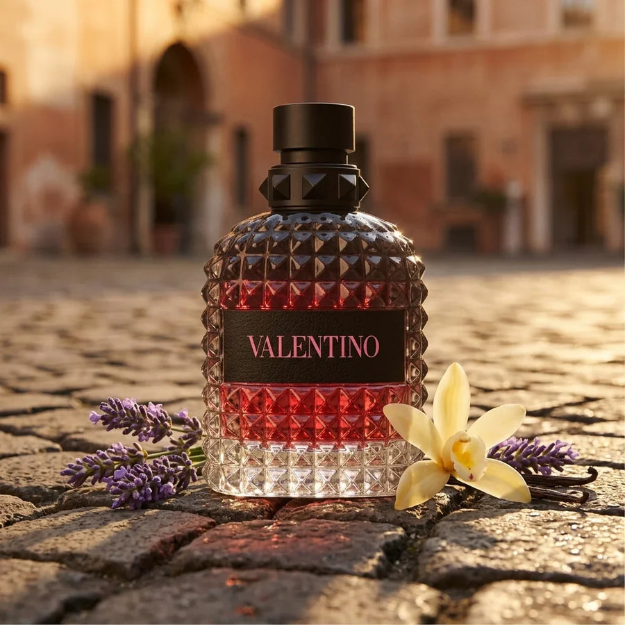 Valentino perfume bottle with a studded design, lavender sprigs, and vanilla flower on cobblestone street