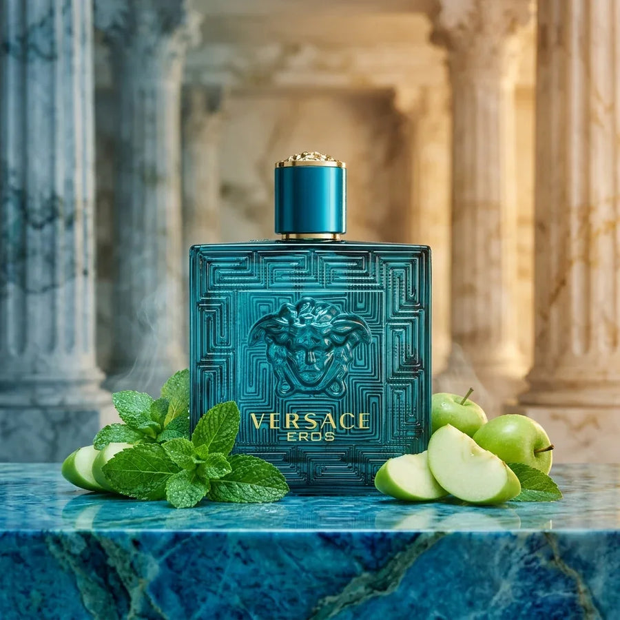 Versace Eros perfume bottle with mint leaves and green apple, set on blue marble with classical columns.