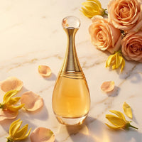 Elegant perfume bottle with gold accents on marble, surrounded by roses and yellow flowers
