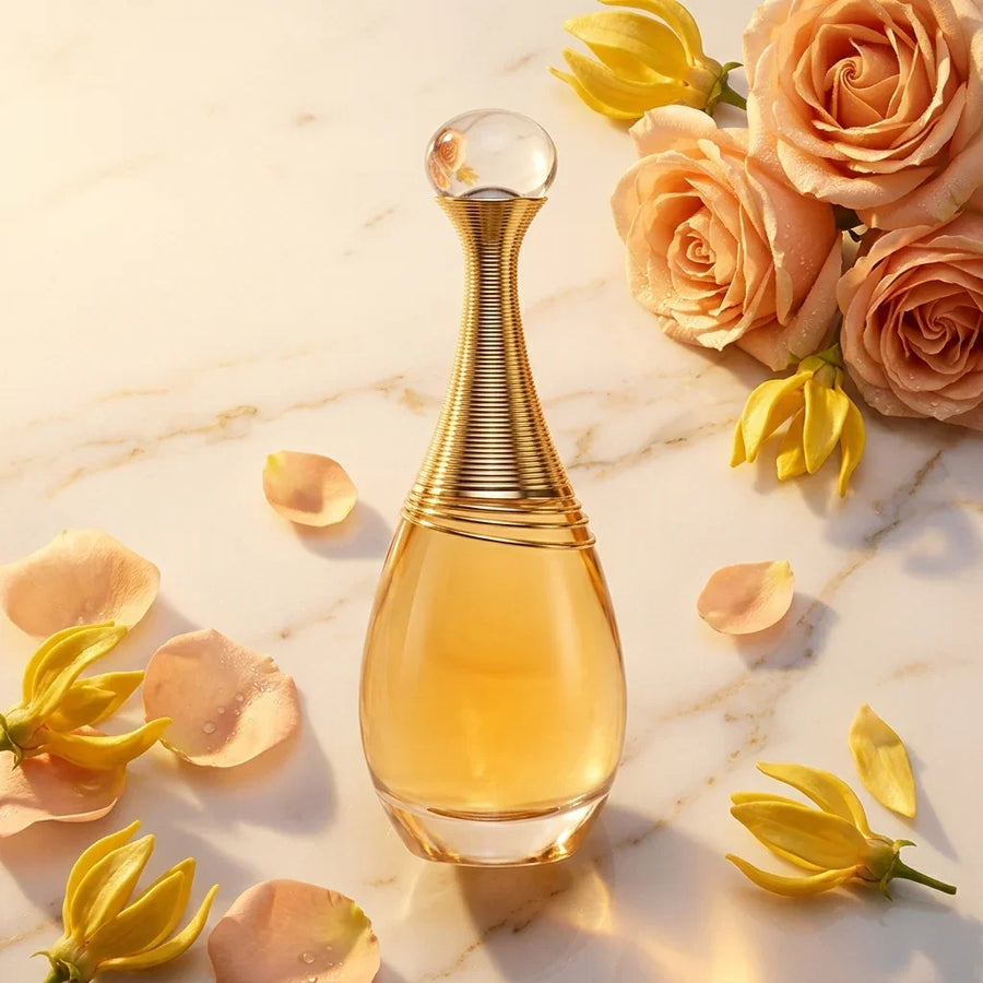 Elegant perfume bottle with gold accents on marble, surrounded by roses and yellow flowers