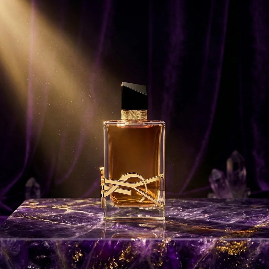 Luxury perfume bottle with gold accents on a marble surface, dramatic lighting