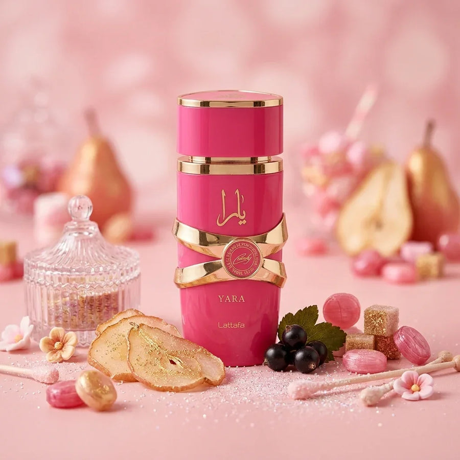Lattafa Yara perfume in a pink and gold bottle surrounded by pear, berries, and sweets