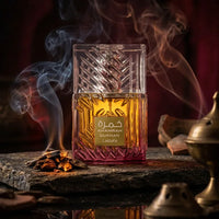 Khamrah Dukhun Lattafa perfume bottle with golden cap, surrounded by smoke and oud chips