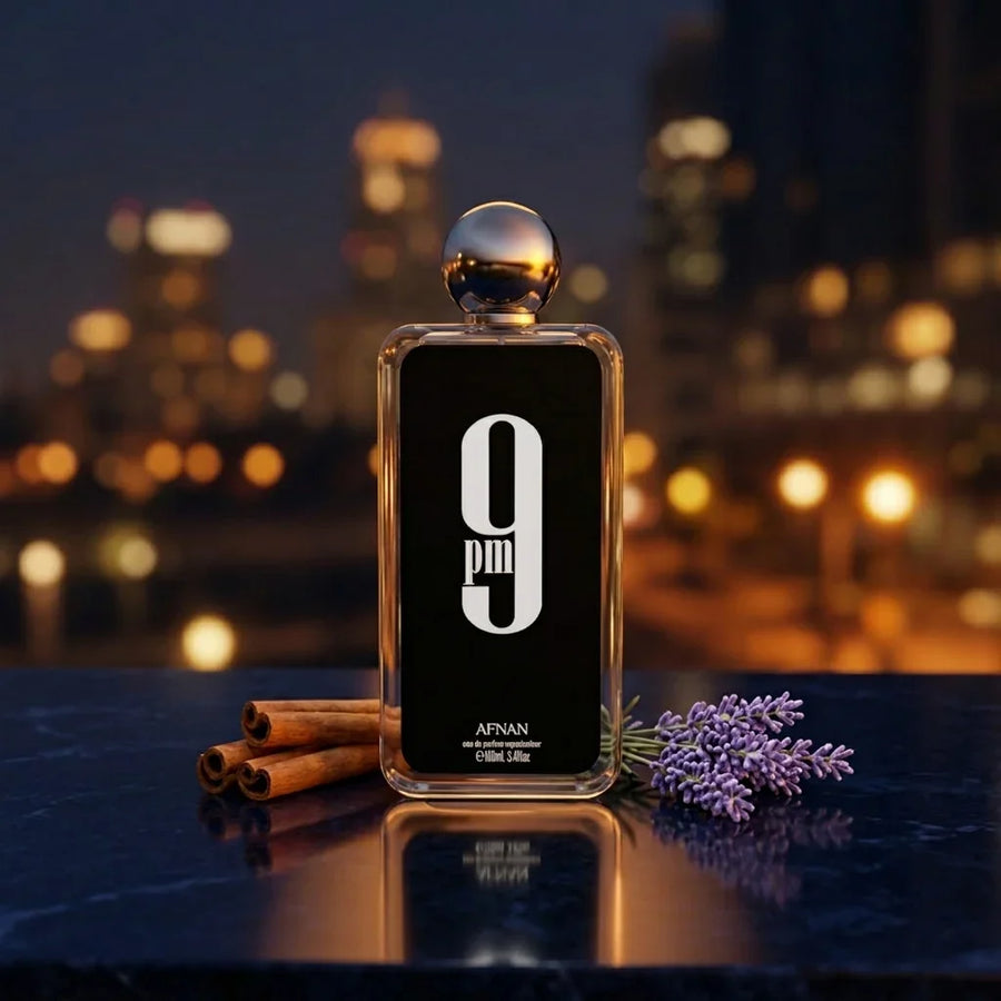 Afnan 9pm perfume bottle on marble with cinnamon sticks and lavender, city lights background