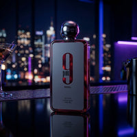 Afnan 9pm Rebel perfume bottle on a bar counter with city lights background